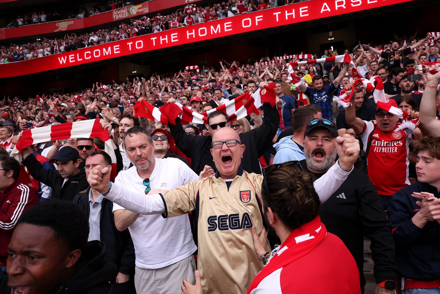 Arsenal supporters sing loud and proud.