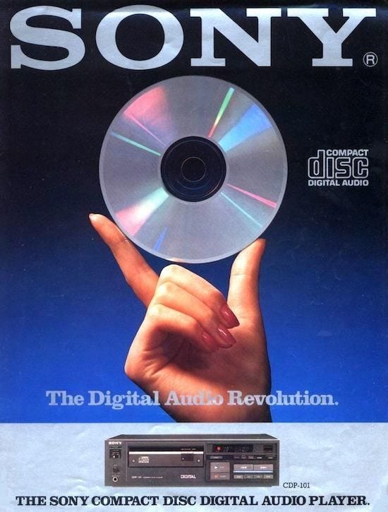 This may contain: an advertisement for sony's digital audio revolution, featuring a hand holding up a disc This may contain: an advertisement for sony's digital audio revolution, featuring a hand holding up a disc