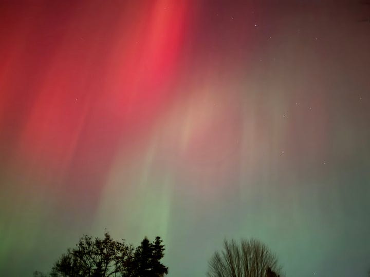 two pictures of the Northern Lights, pink and green shimmering in night sky