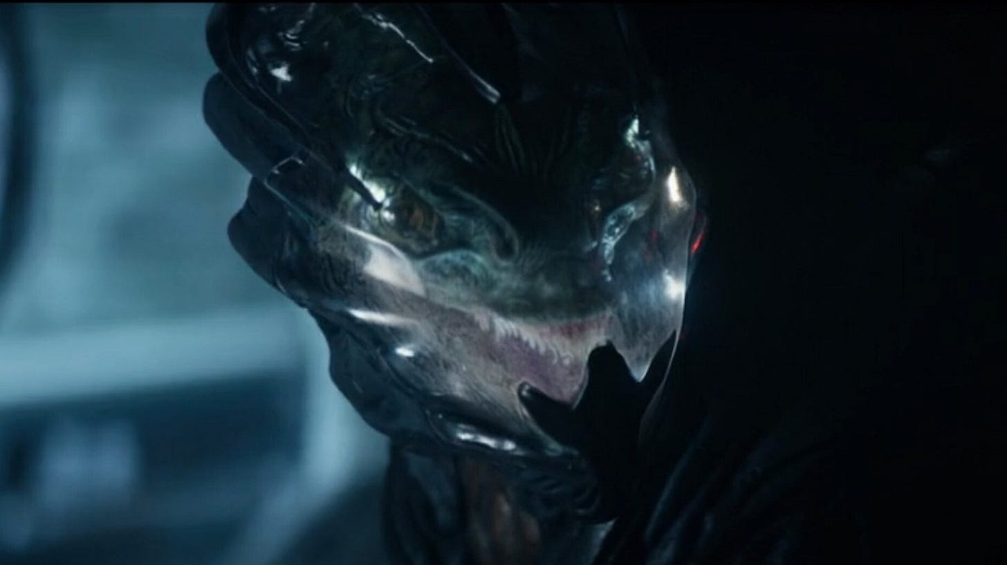 Close-up of a modern Gorn wearing a dark, organic-looking extravehicular suit in Star Trek: Strange New Worlds. Close-up of a modern Gorn wearing a dark, organic-looking extravehicular suit in Star Trek: Strange New Worlds.
