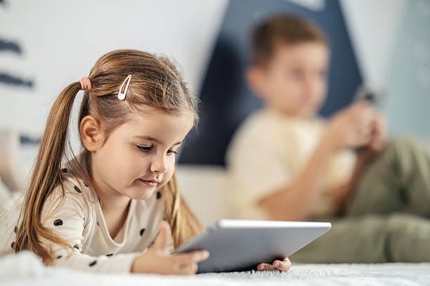 Young girl and boy using digital tablets Children are looking at their tablet and smart phone devices, enjoying screen time for education or entertainment at home screen time and children stock pictures, royalty-free photos & images Young girl and boy using digital tablets Children are looking at their tablet and smart phone devices, enjoying screen time for education or entertainment at home screen time and children stock pictures, royalty-free photos & images