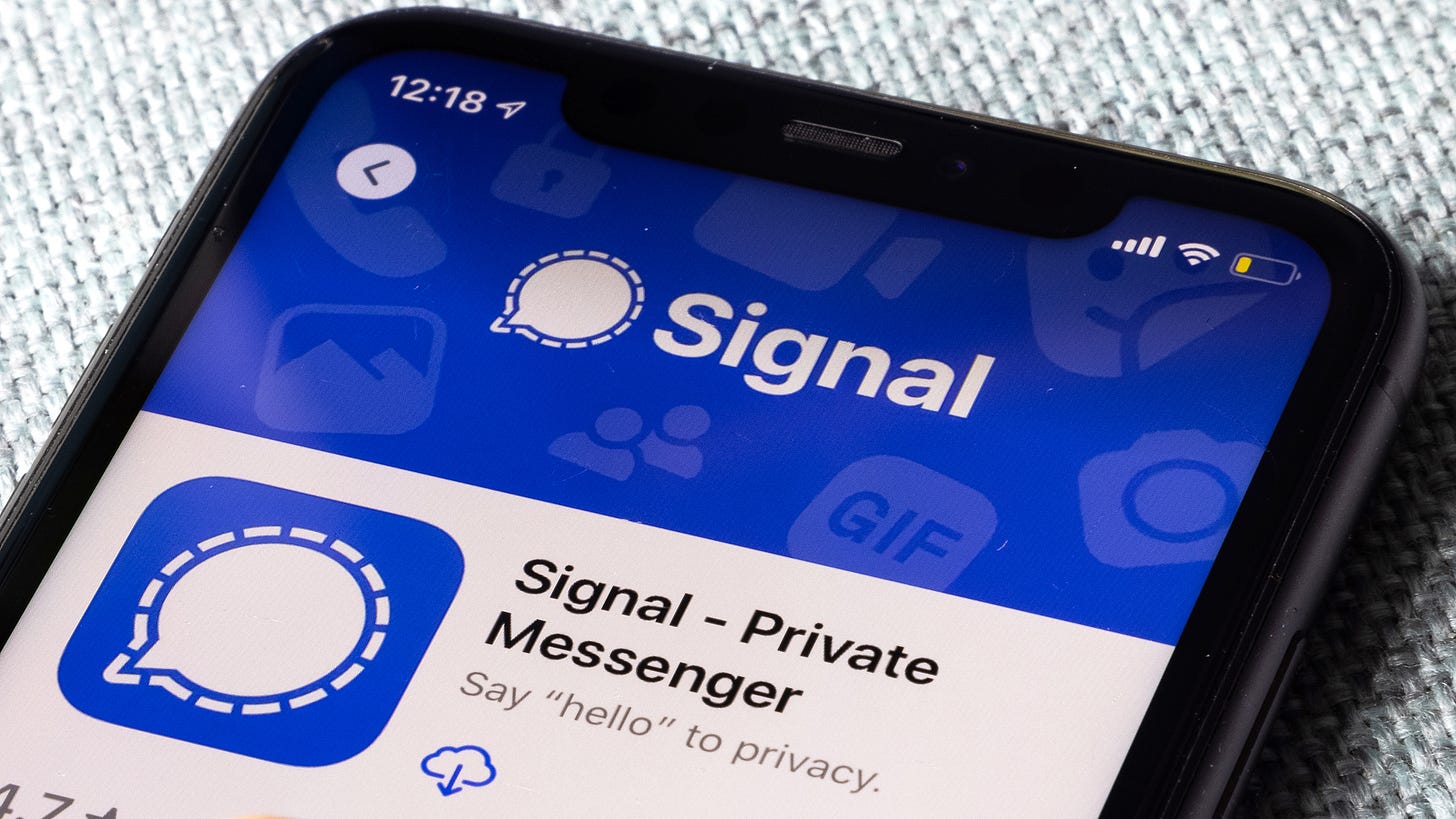 A smartphone on a table showing the Signal app
