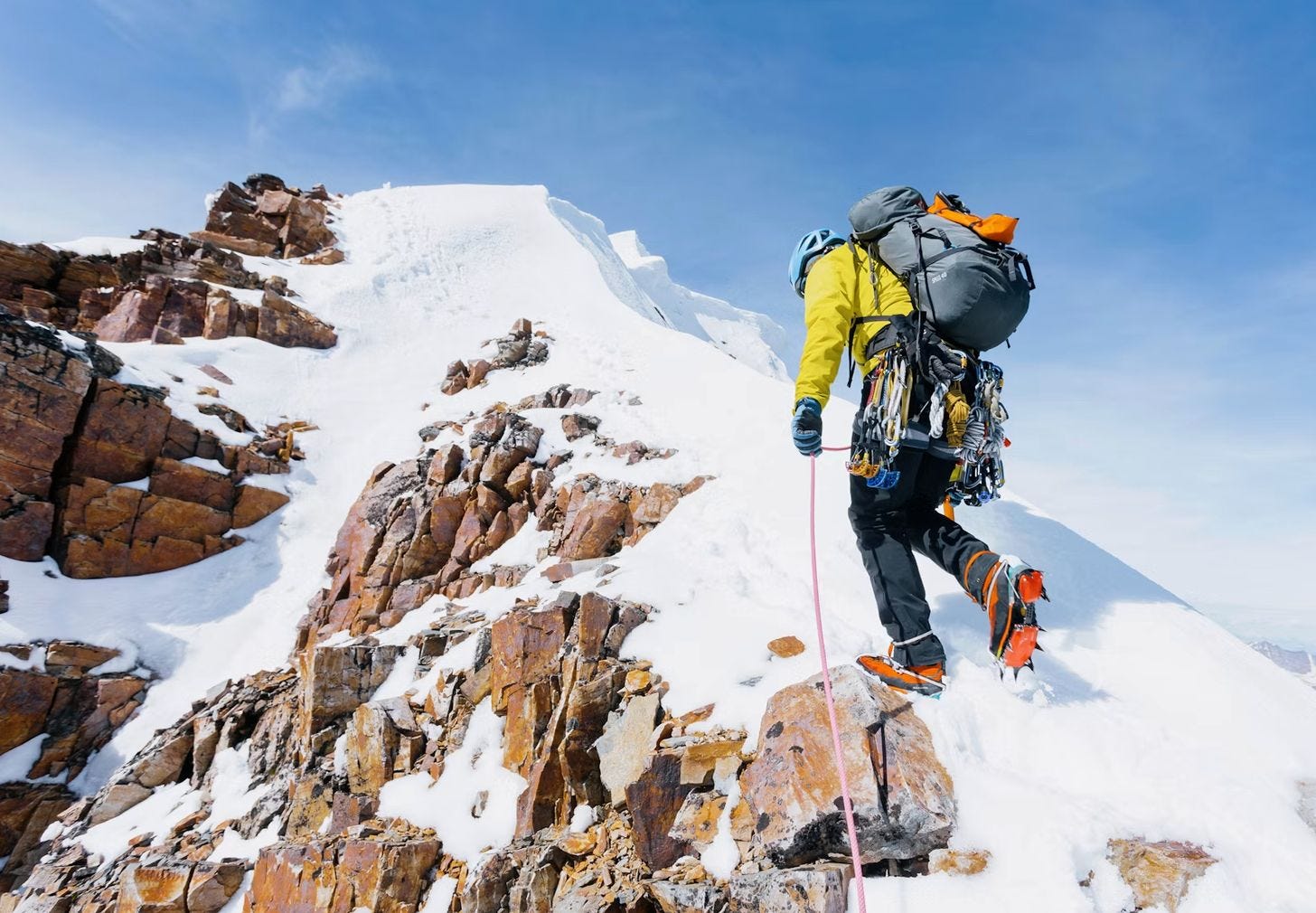 Climber reaching the summit ridge of Mt. Edith Cavell in Jasper National Park, Canada.