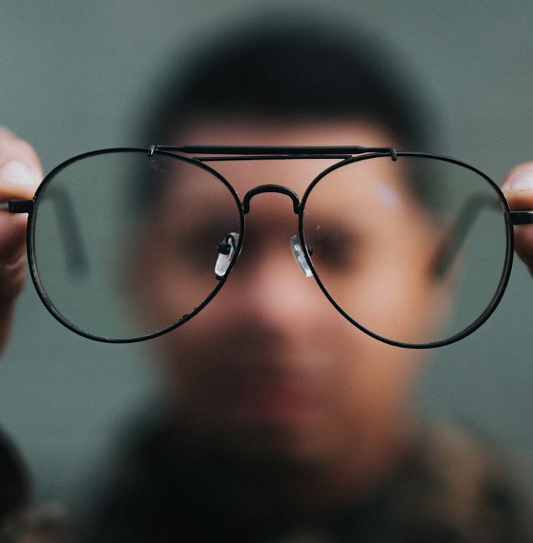 man holding eyeglasses