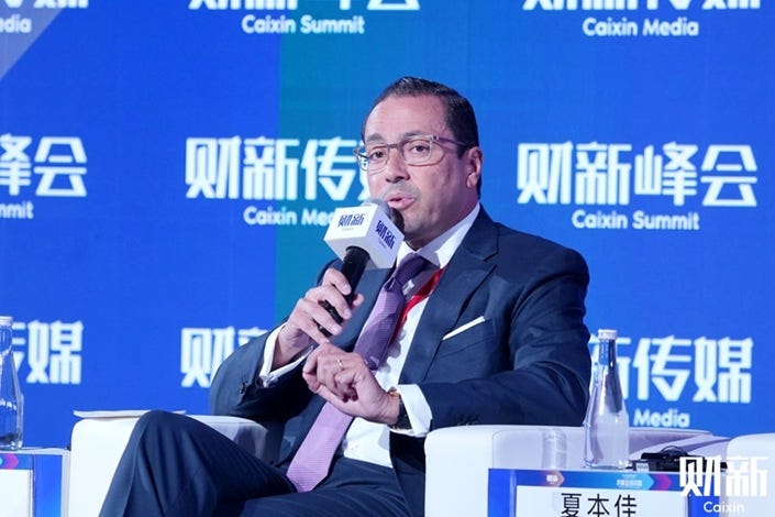 Investcorp Co-Chief Exectuive Officer Hazem Ben-Gacem delivers a speech at the 14th Caixin Summit in Beijing Nov. 9. Photo: Caixin