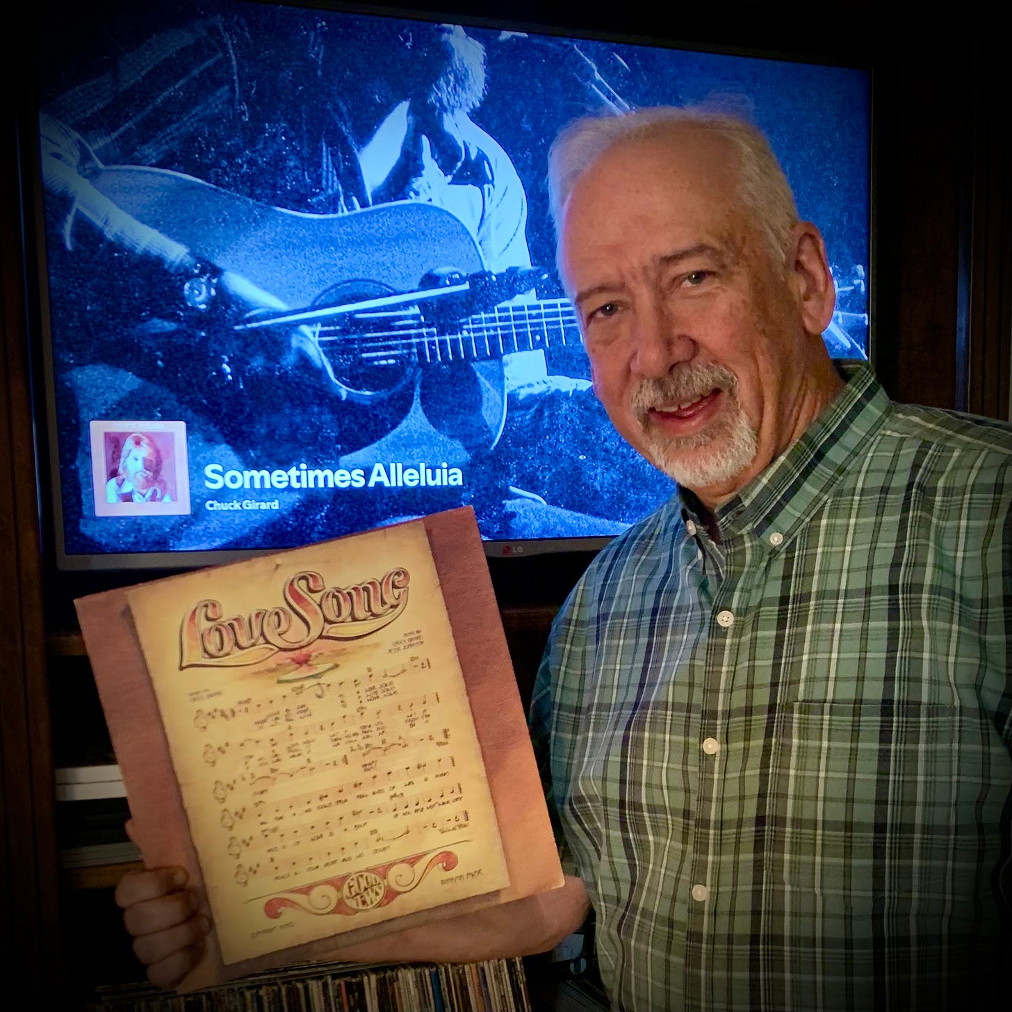 Image of David Guion holding the original 1974 Love Song LP record.