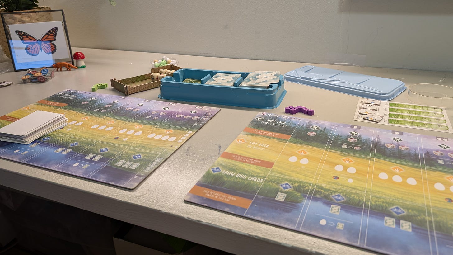The game Wingspan set up for two players on a desk, with the two player mats side-by-side