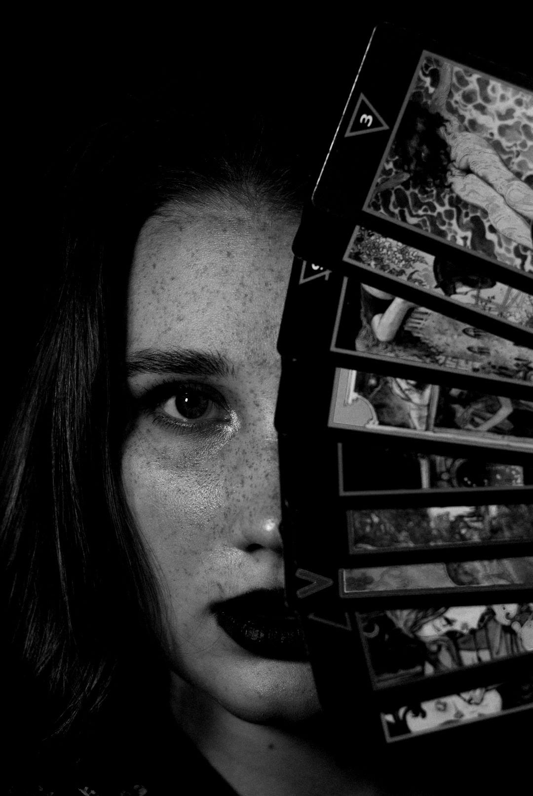 a woman holding up a stack of photos a woman holding up a stack of photos