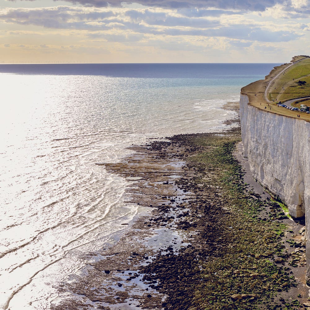 a sea cliff with a rocky base