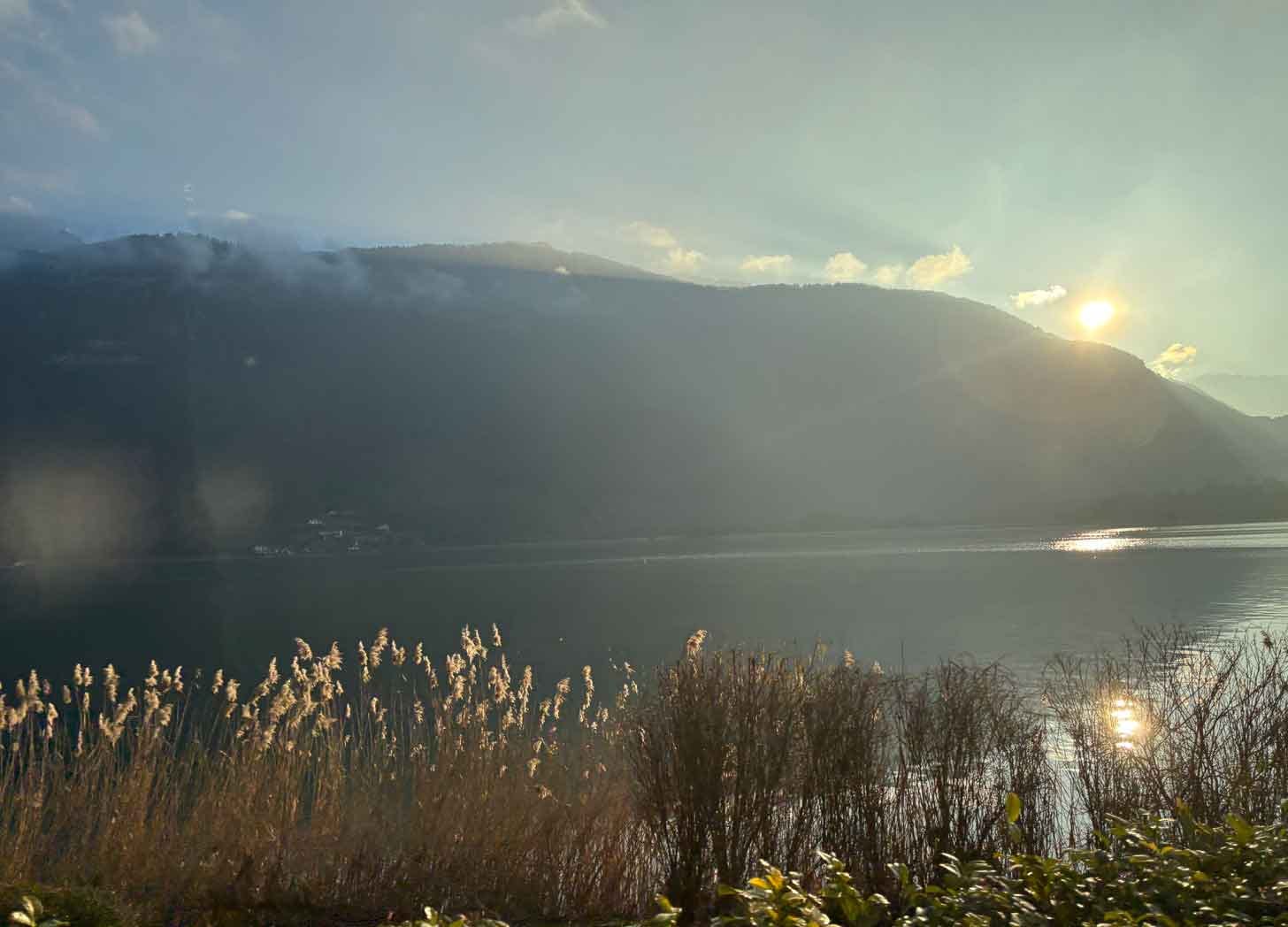 Lake Annecy from the Coach, sun creeping round the corner