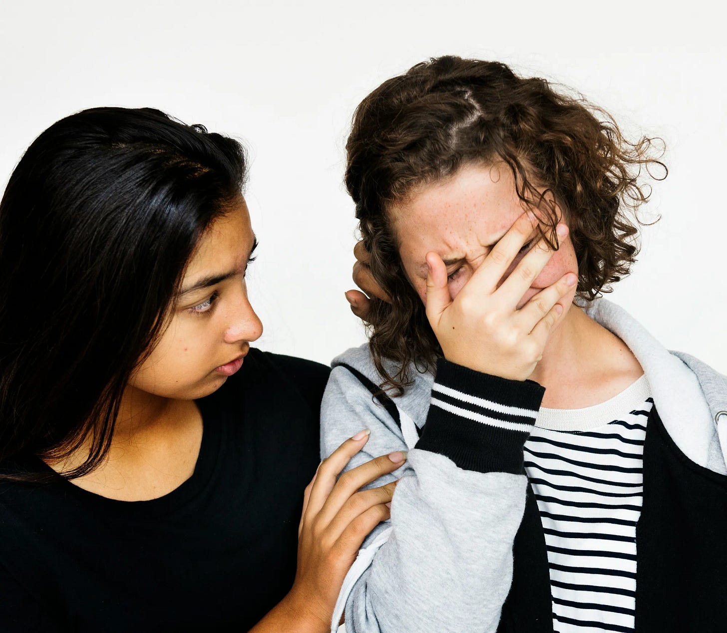 two woman, one upset and the other supporting her