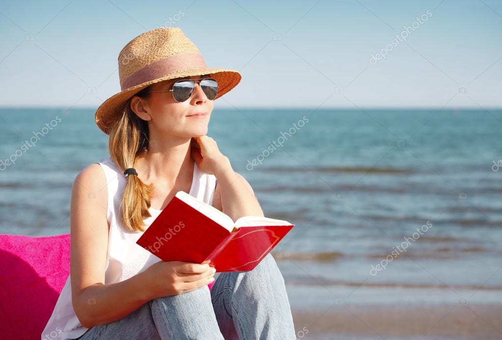 Woman reading book on the beach — Stock Photo © Sepy #115113980