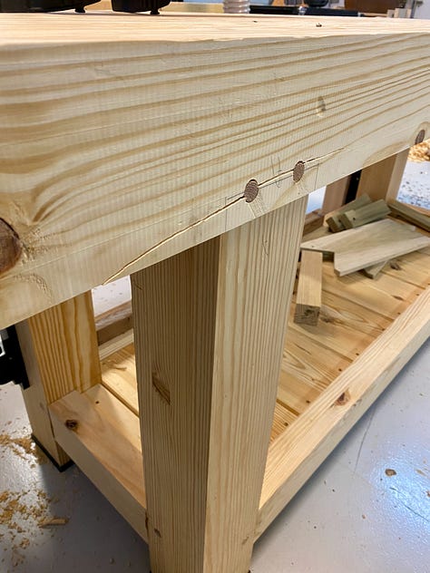 Various images of the workbench showing a crack in the top, gaps in the top being filled, and a plane stop sitting on the top.