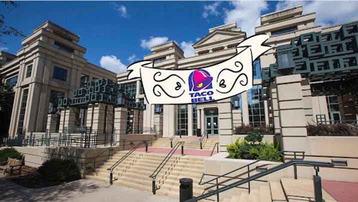 A Taco Bell banner hung up on the John Pappajohn Business Building.