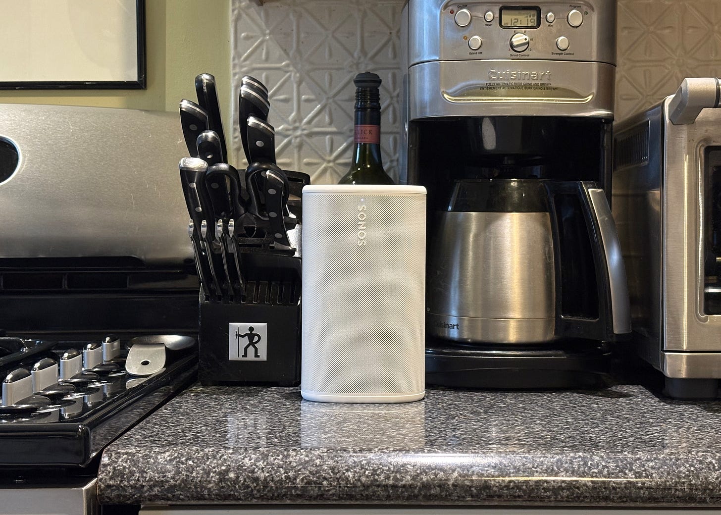A white Sonos Play seen on a kitchen counter, in front of a coffee maker. A white Sonos Play seen on a kitchen counter, in front of a coffee maker.