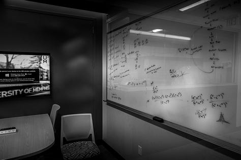 scenes from around campus including a classroom with calculations on whiteboard, ceiling images of cables to power makers space, University of Memphis logo on a chair and window, buildings