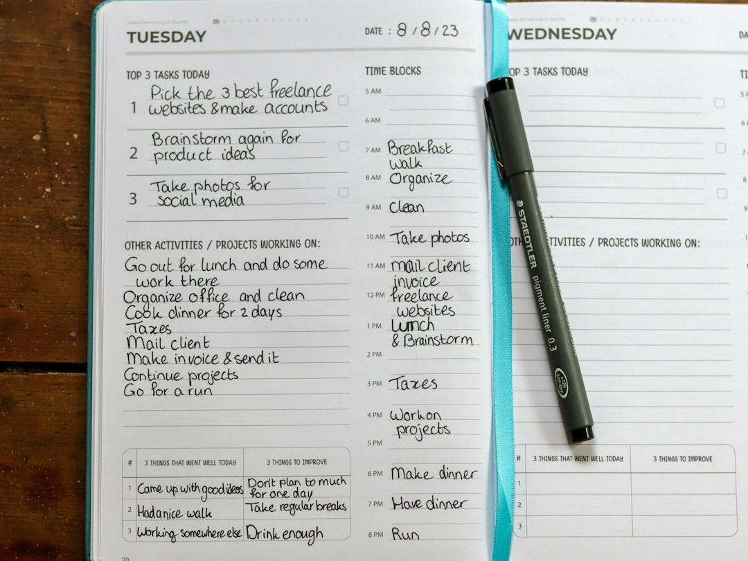 a planner with a pen on top of it