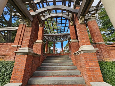 The garden with brick gazebo and fountain that is not running.