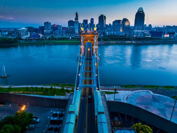 Aerial view of Suspension Bridges and James Roebling Bridge crossing Ohio River from Covington Kentucky to Cincinnati, Ohio. Aerial view of Suspension Bridges and James Roebling Bridge crossing Ohio River from Covington Kentucky to Cincinnati, Ohio.