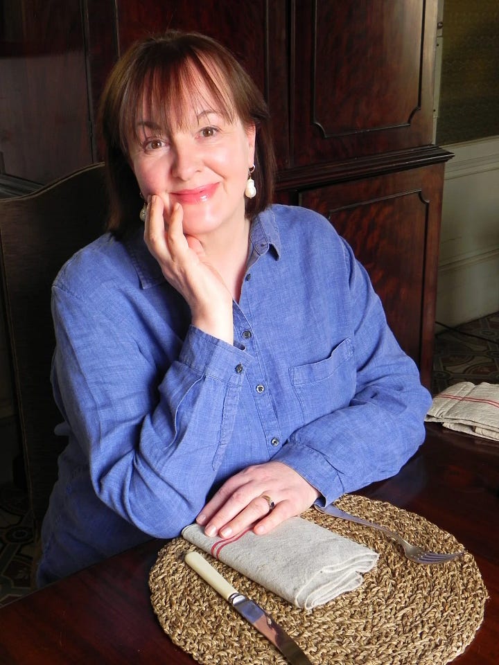 writer debora robertson wearing a blue shirt sitting at a table