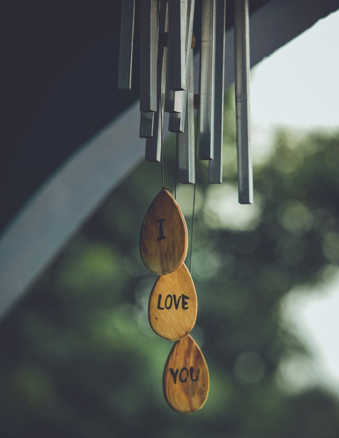 focus photography of gray and brown wind chimes