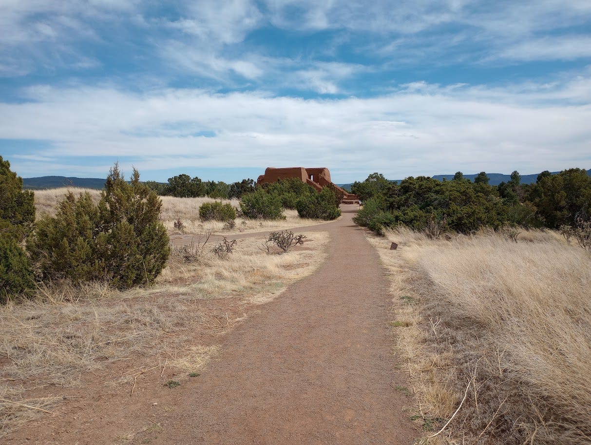 Archeological remains of large building set in desert and blue skies