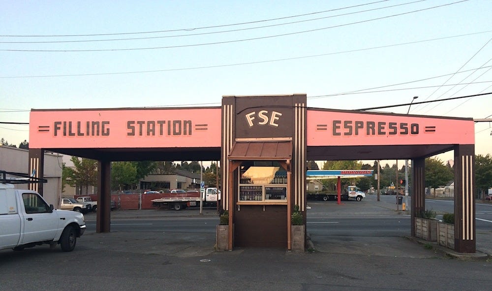 The facade of Olympia's drive-thru Filling Station Espresso stand, painted in chocolate brown, pink, and cream