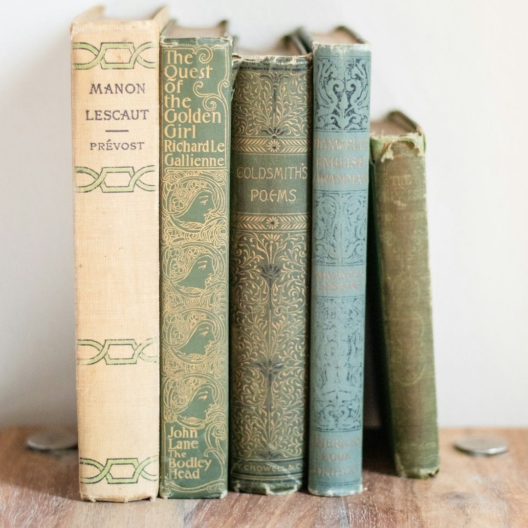 a row of books sitting on top of a wooden table