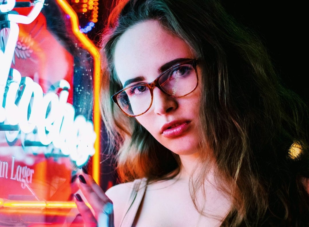 woman standing near neon light signage