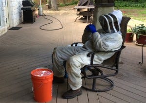 Jim rests after removing the bees and preserving the honey. Jim rests after removing the bees and preserving the honey.