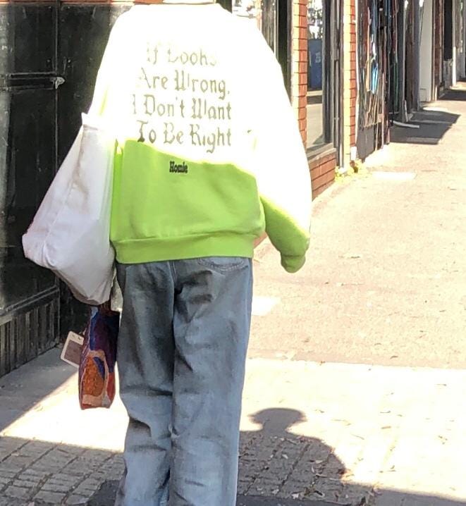 Photo of someone with a top that says on the back 'If books are wrong I don't want to be right'