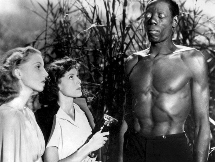 This may contain: two women standing next to a man with no shirt on in front of some trees