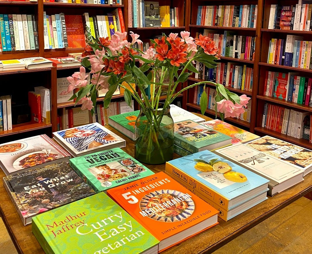 a vase of flowers on a table in a library