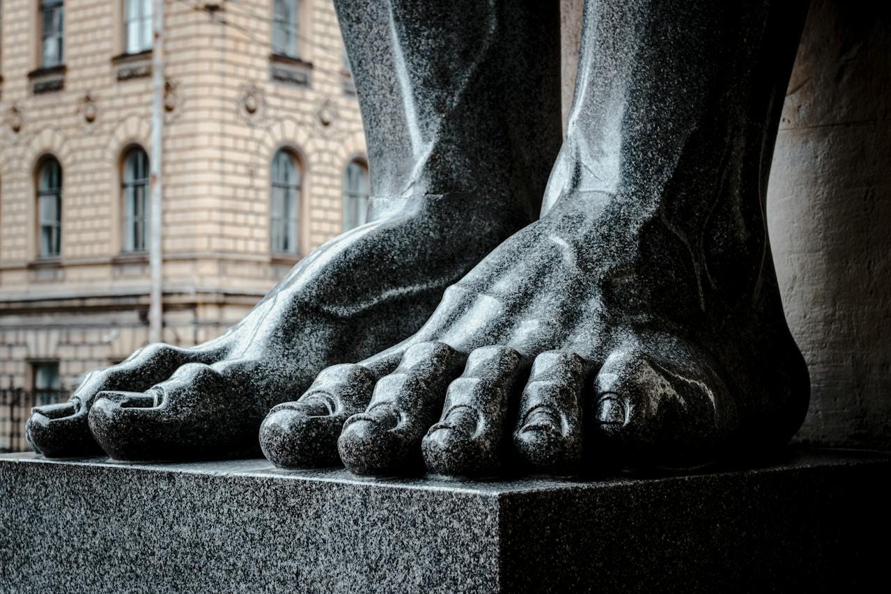 Stone feet at the base of a statue Stone feet at the base of a statue