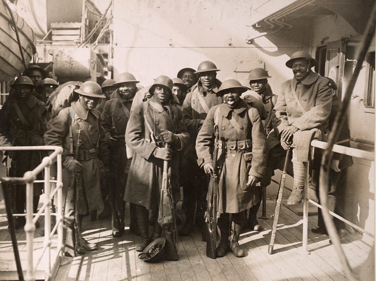 Members of the all-Black 369th, or Harlem Hellfighters, pose on the boat home from World War I after fighting valiantly, Feb. 10, 1919. Photo via National Archives, originally captured by Western Newspapers Union Members of the all-Black 369th, or Harlem Hellfighters, pose on the boat home from World War I after fighting valiantly, Feb. 10, 1919. Photo via National Archives, originally captured by Western Newspapers Union