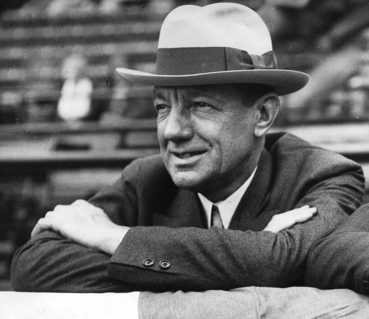 William Veeck seated in the grandstand, looking out at the field. William Veeck seated in the grandstand, looking out at the field.