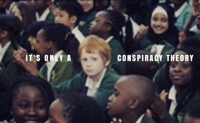 A group of children in green school uniforms sitting closely together in what appears to be a classroom or assembly. Text overlay reads "IT\'S ONLY A CONSPIRACY THEORY" in white capital letters.