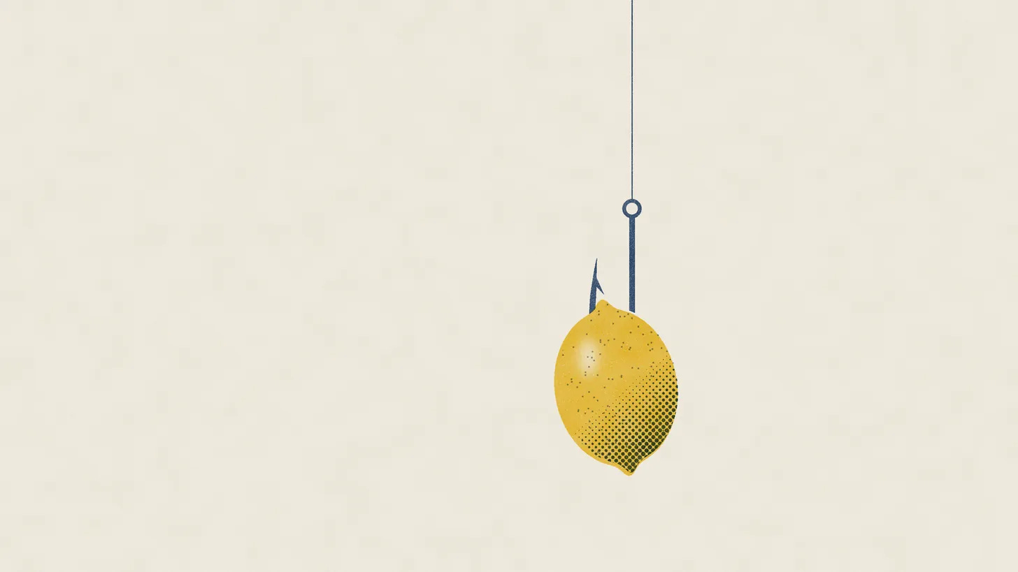 A lemon hanging from a fishhook on a single line, against a pale, empty background. A lemon hanging from a fishhook on a single line, against a pale, empty background.