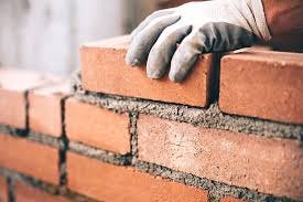 Close-up of a mason laying bricks Close-up of a mason laying bricks