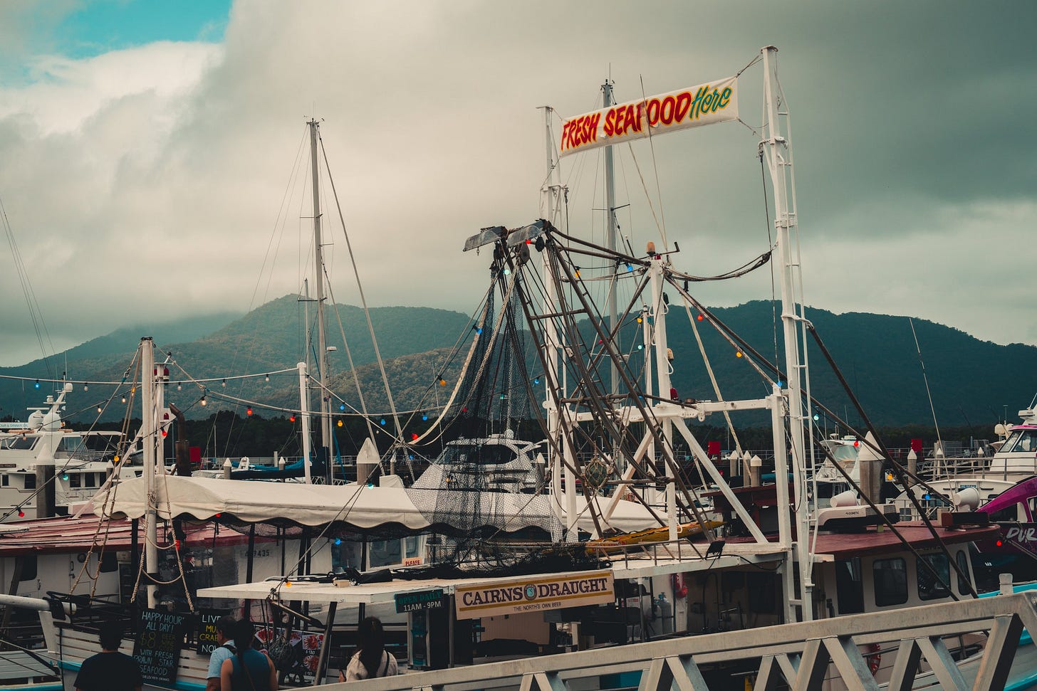 Marina with Fishing Boats and Seafood Sign