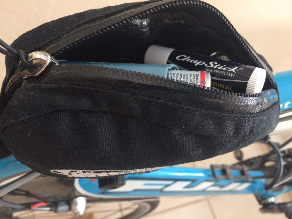 Chapstick tube sitting in an open  black top tube gear pacl