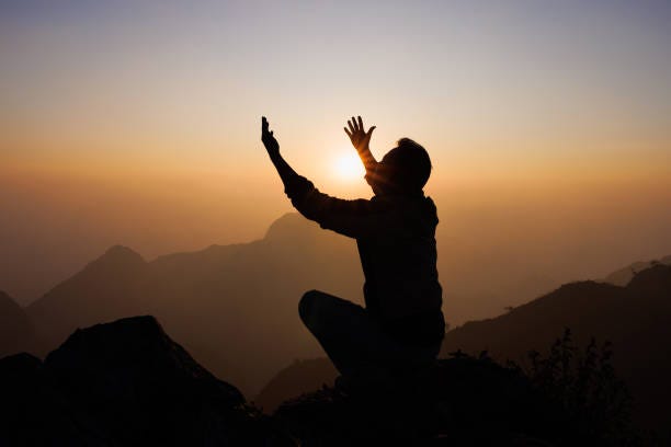Silhouette of a man is praying to God on the mountain. Praying hands with faith in religion and belief in God on blessing background. Power of hope or love and devotion. Silhouette of a man is praying to God on the mountain. Praying hands with faith in religion and belief in God on blessing background. Power of hope or love and devotion. man asking forgiveness stock pictures, royalty-free photos & images