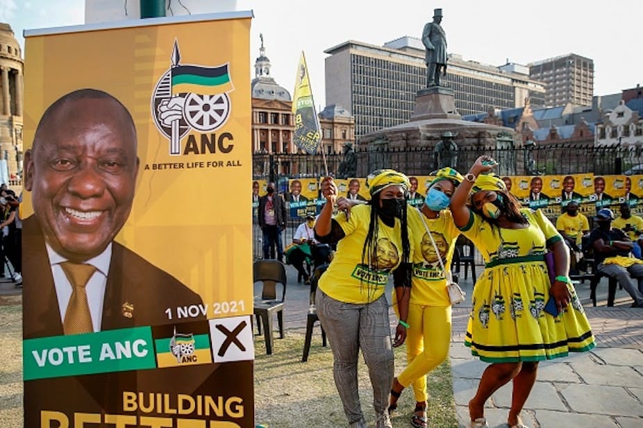 An election poster bearing the face of a smiling man. An election poster bearing the face of a smiling man.