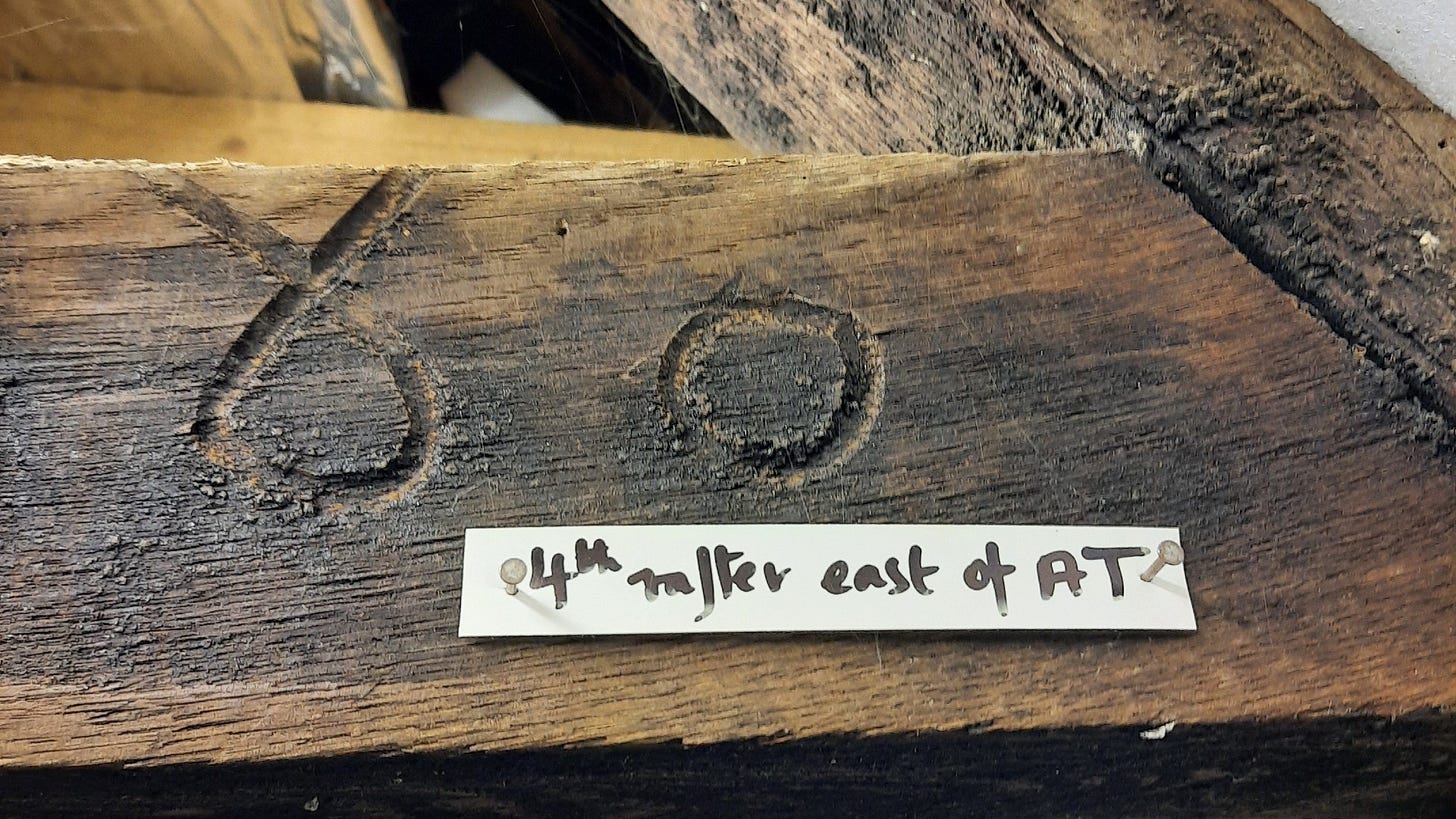 'Cursive freehand Arabic numerals (4 and 5) carved as assembly markers by the original carpenters in the roof timbers of West Court Farm, a manor house in Wiltshire, England. The numerals were dated by dendrochronology to 1316, two centuries before Arabic numerals were in common use in England.' [photo by Diana Darke taken 6 June 2019].