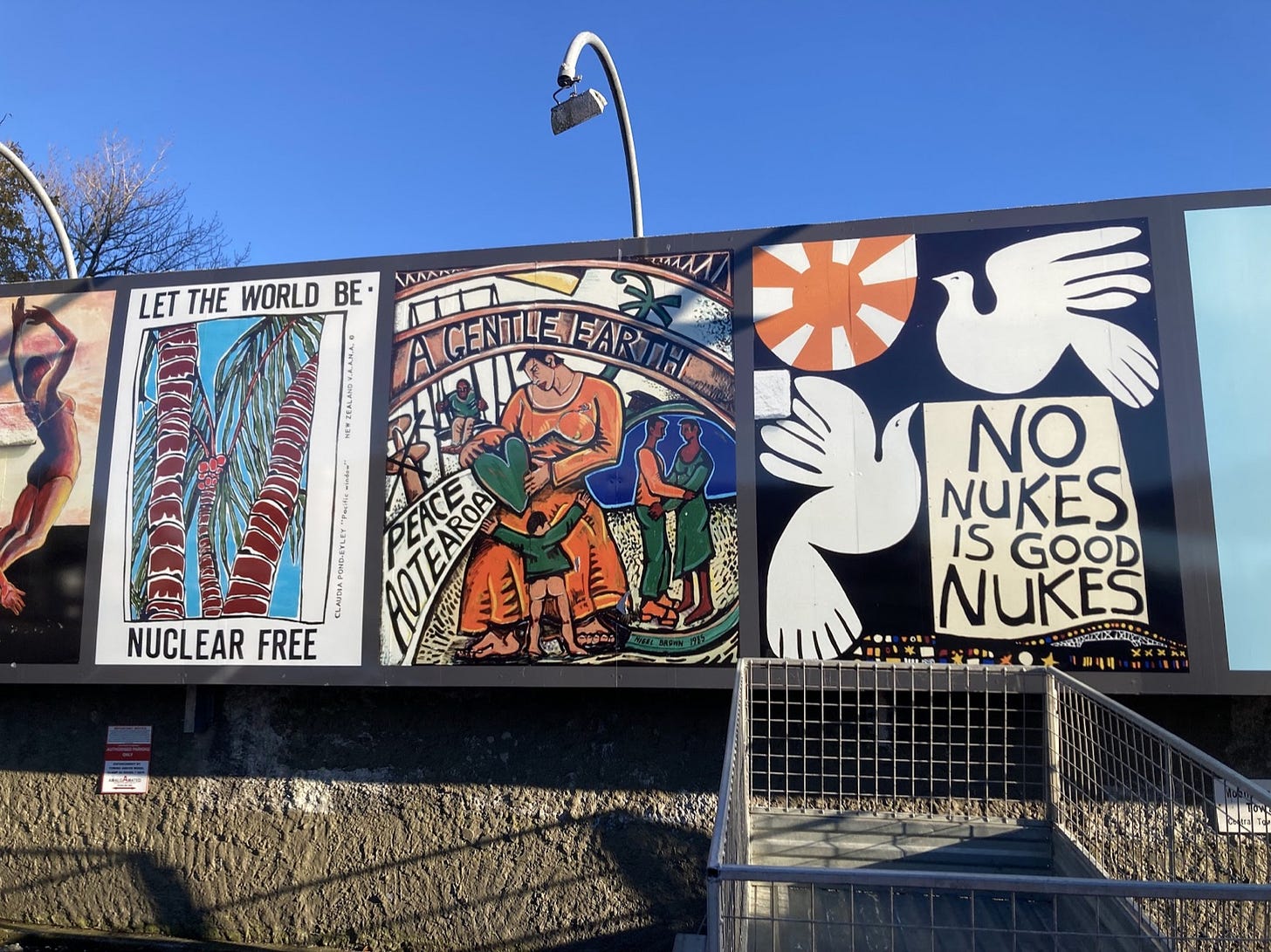Anti-nuclear murals on a wall: 'Let the world be nuclear free', 'A gentle earth, peace Aotearoa', and 'No nukes is good nukes' Anti-nuclear murals on a wall: 'Let the world be nuclear free', 'A gentle earth, peace Aotearoa', and 'No nukes is good nukes'
