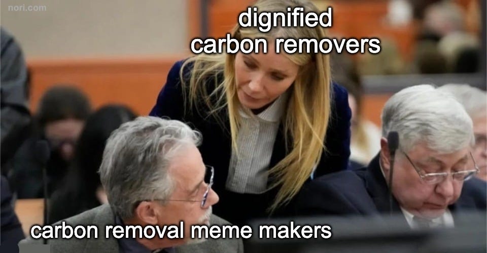 A woman in a courtroom leans over an older man. She is labelled "dignified carbon removers"; he is labelled "carbon removal meme makers".