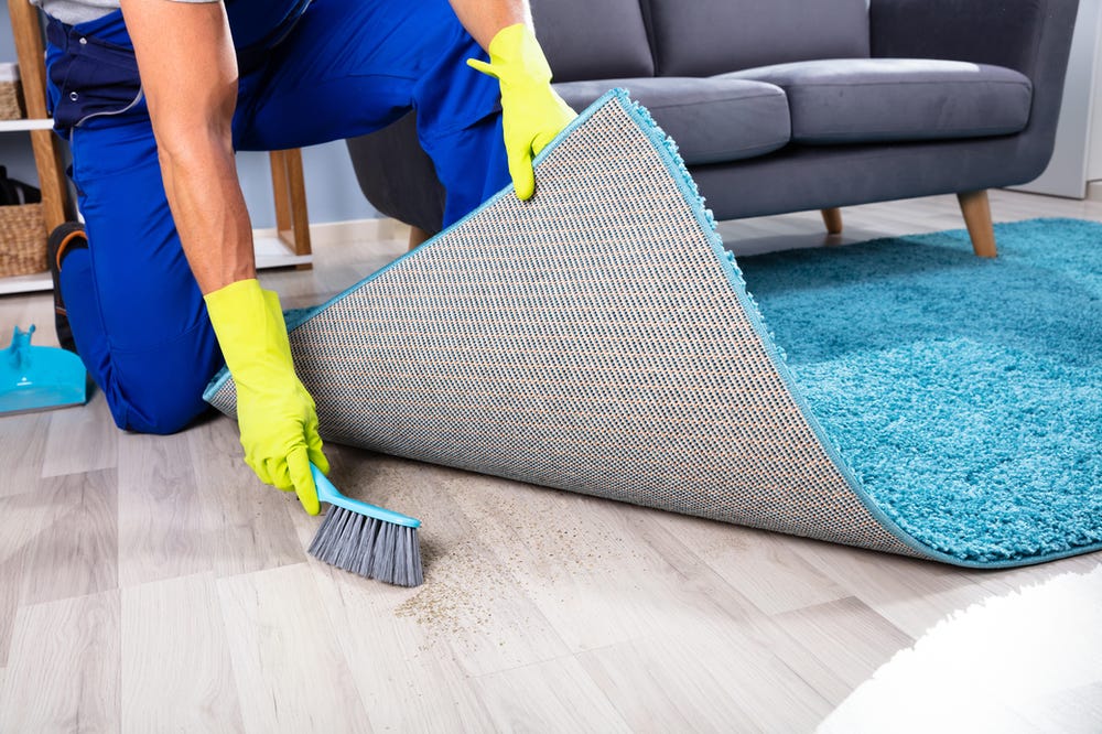 Dirt being swept beneath a rug