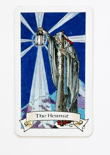 Tarot card with a figure and blue radiating background