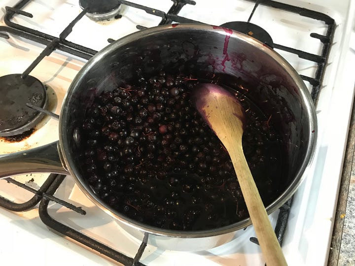 Shiny black fruits after harvest and being cooked in a pan