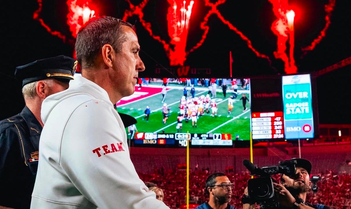 Wisconsin head coach Luke Fickell stands on the field at Camp Randall Stadium as red fireworks illuminate the sky following the Badgers’ victory over USC. Wisconsin head coach Luke Fickell stands on the field at Camp Randall Stadium as red fireworks illuminate the sky following the Badgers’ victory over USC.